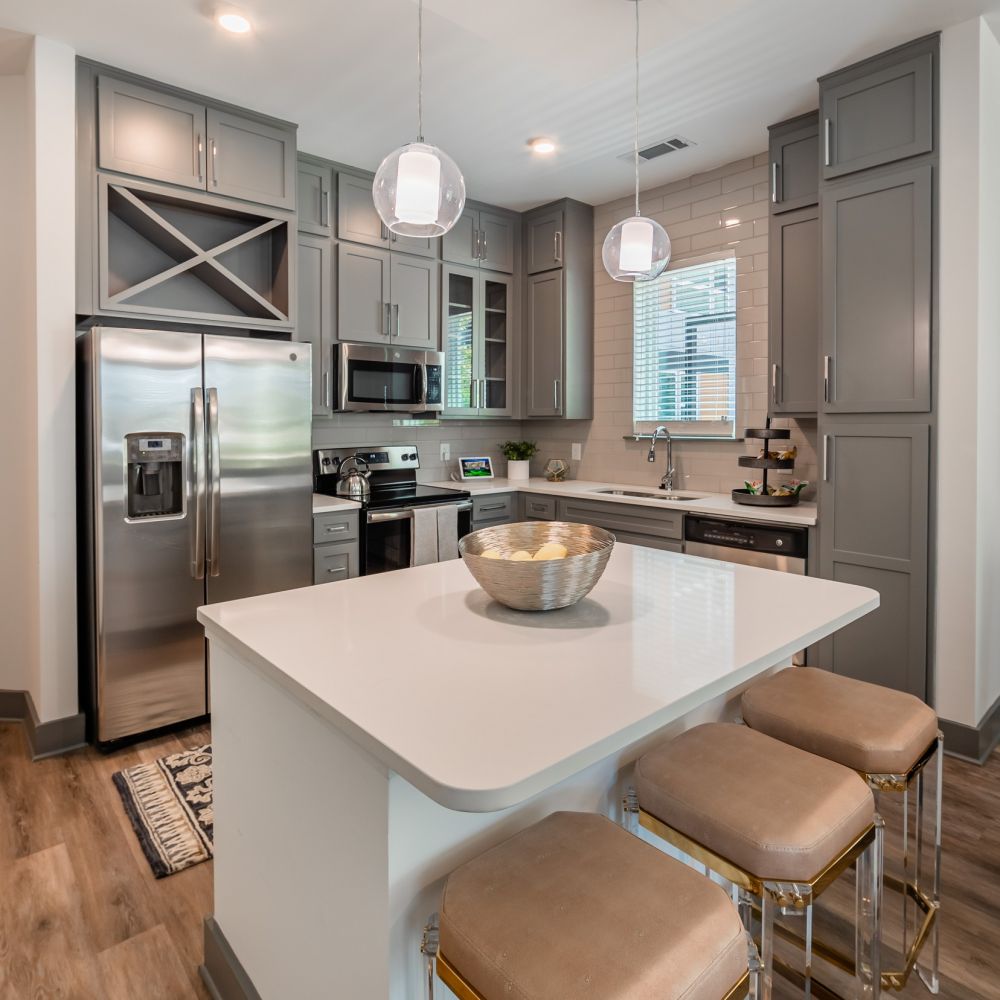 Uptown 550 midrise luxury kitchen with high ceilings, kitchen island, and stainless steel appliances