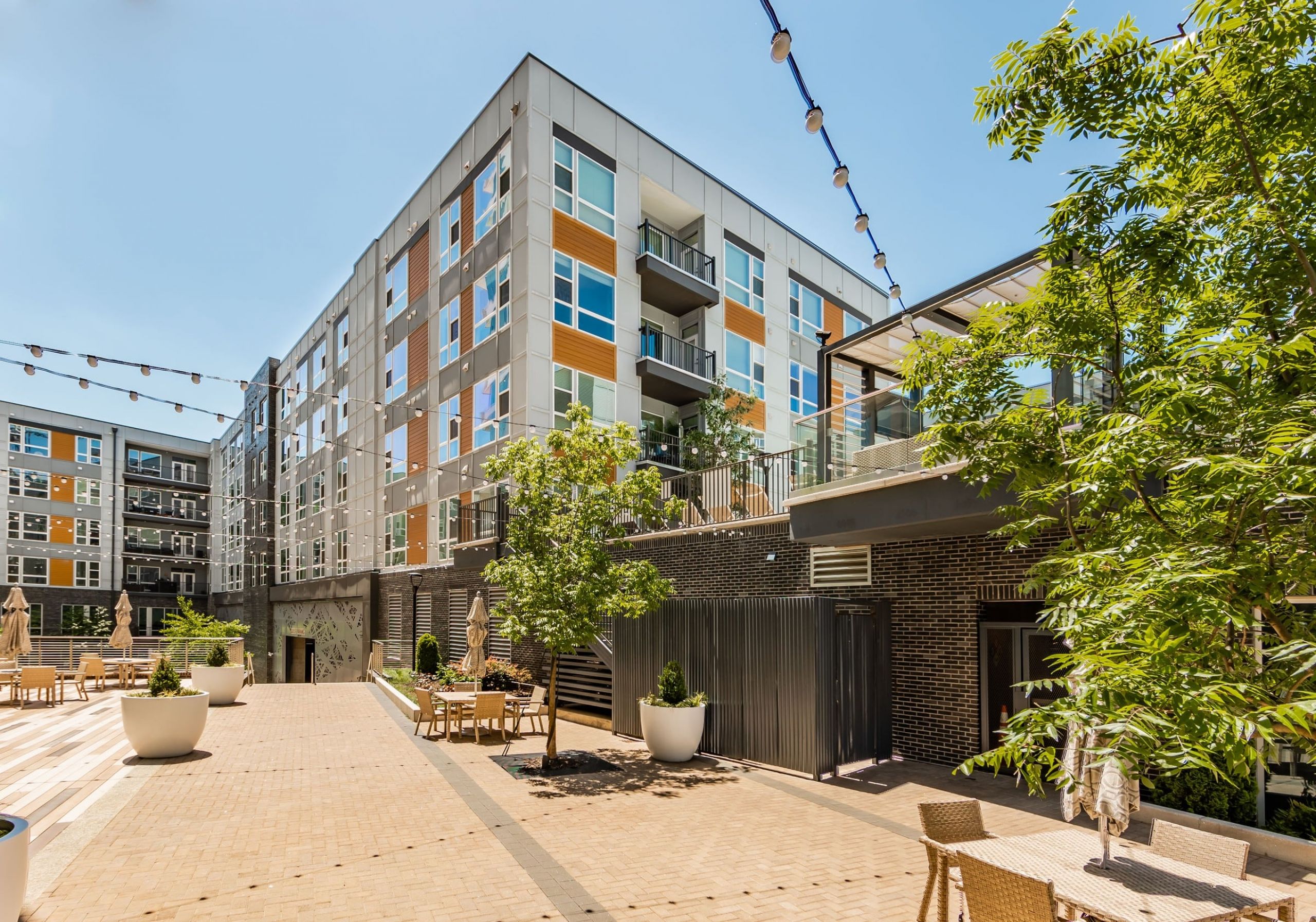 Uptown 550 Exterior seating area with overhead string lights