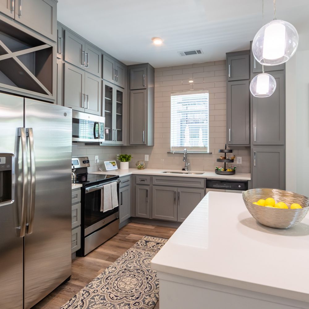 Uptown 550 Midrise spacious kitchen with custom cabinetry and stainless steel appliances