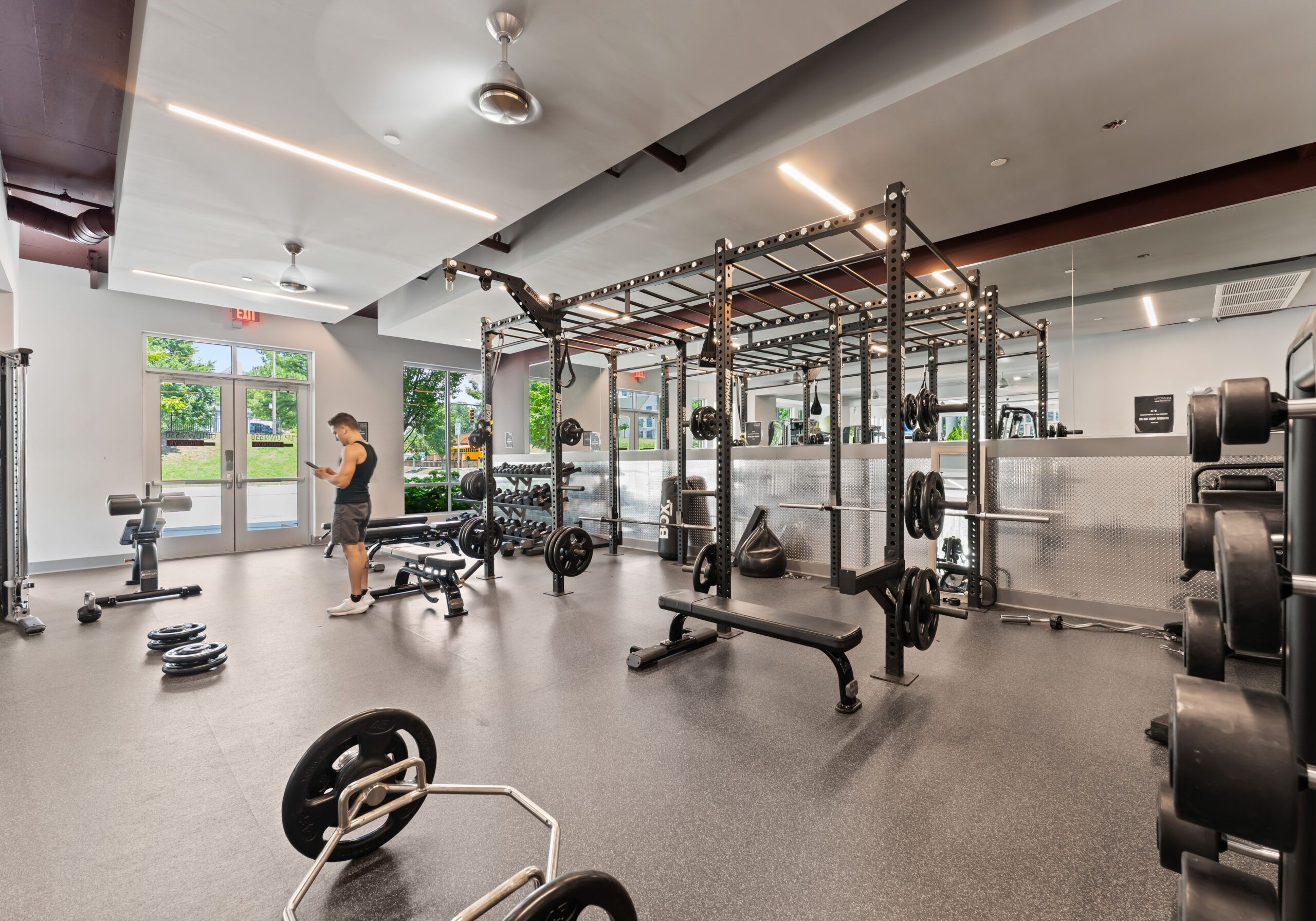 Residents in swimsuits walking in the pool area at Uptown 550 on Brooklyn apartments