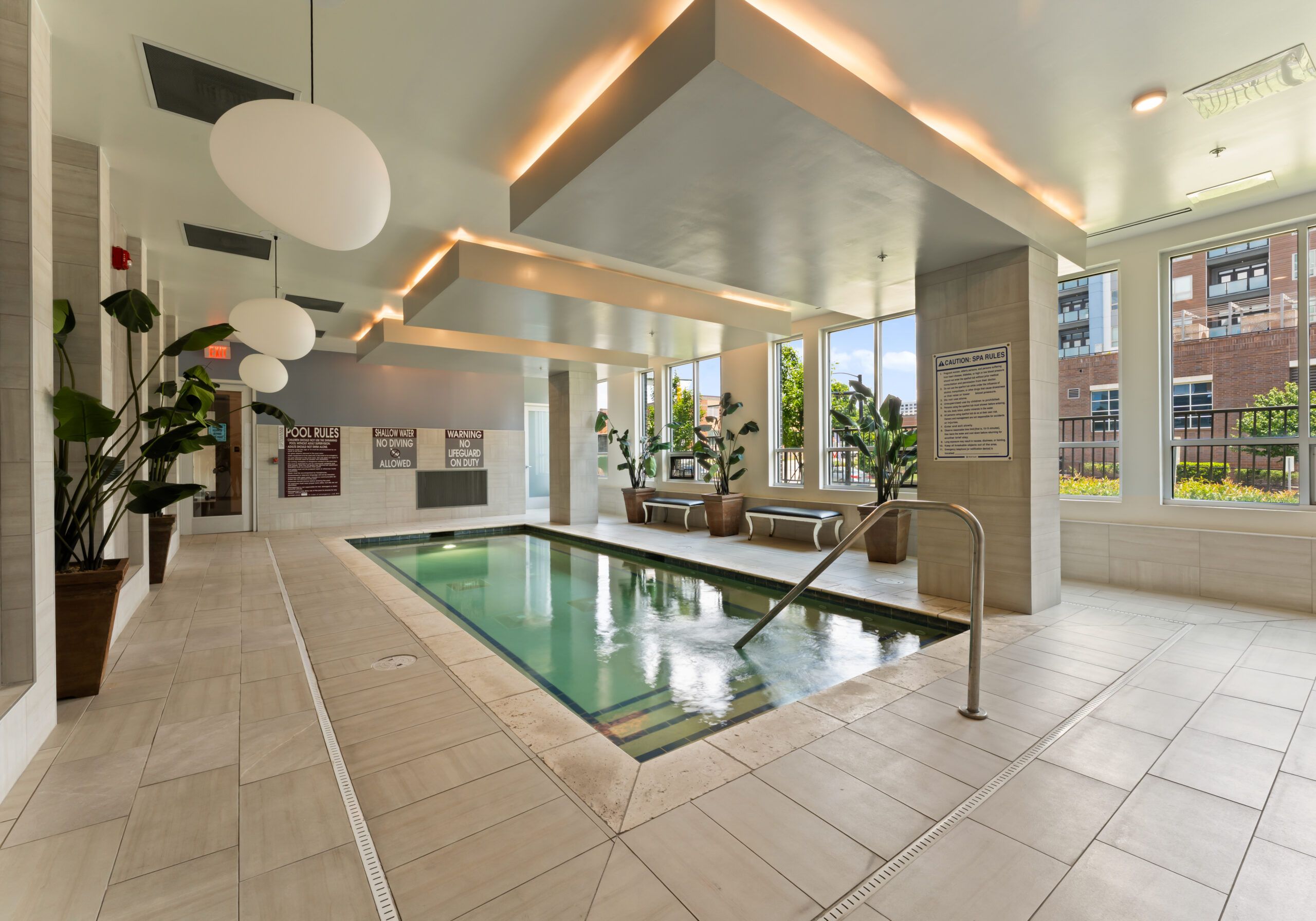Residents enjoying drinks on the rooftop deck at Uptown 550 on Brooklyn apartments