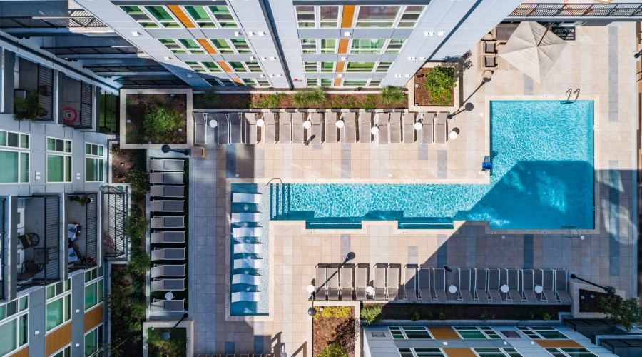 Uptown 550 Luxury apartment building pool with seating area around it.