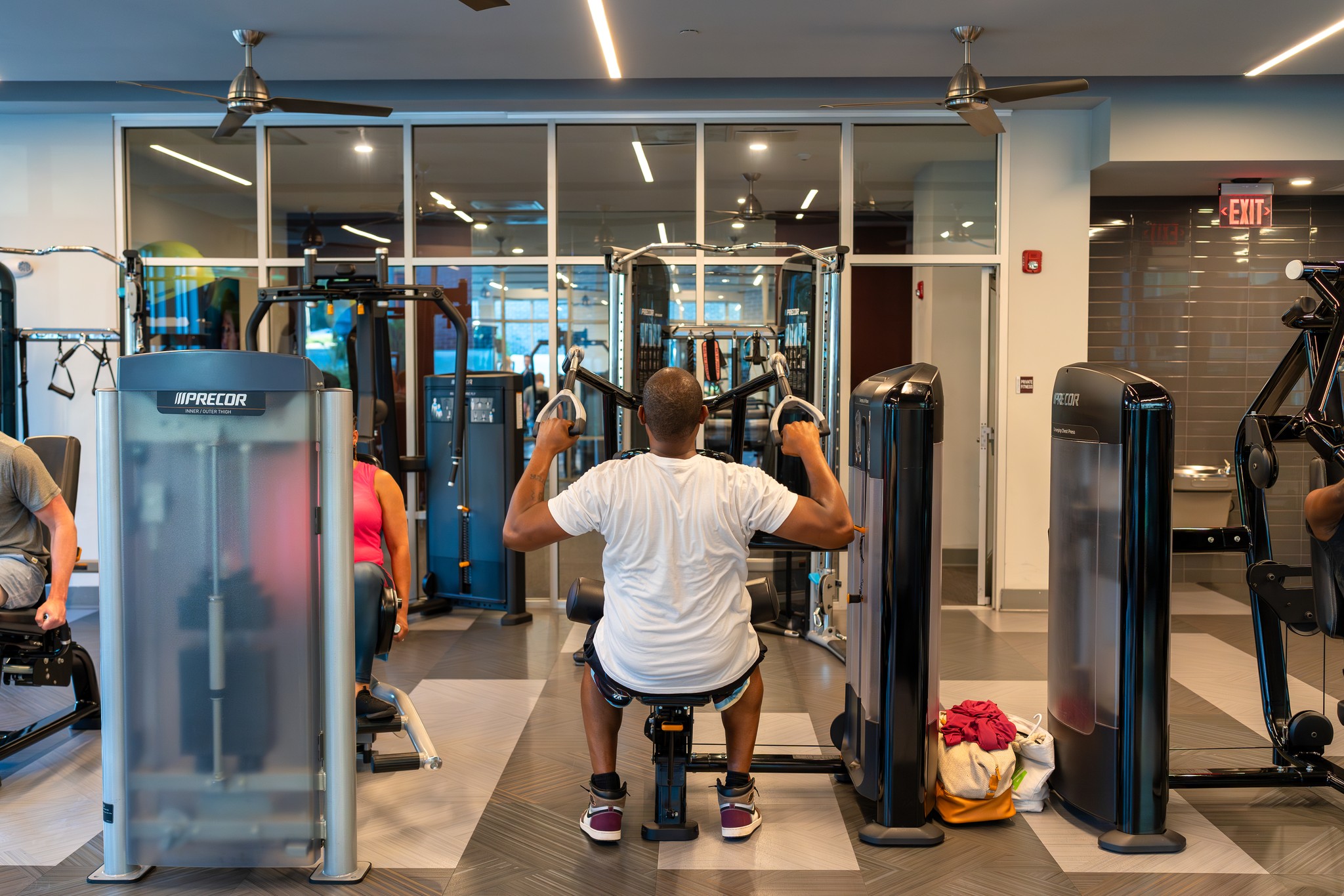 Residents using the gym strength training equipment at Uptown 550 on Brooklyn apartments