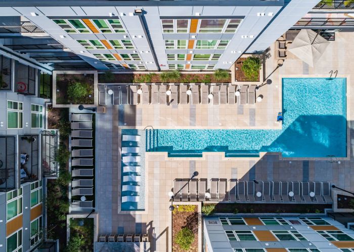 Uptown 550 Luxury apartment building pool with seating area around it.
