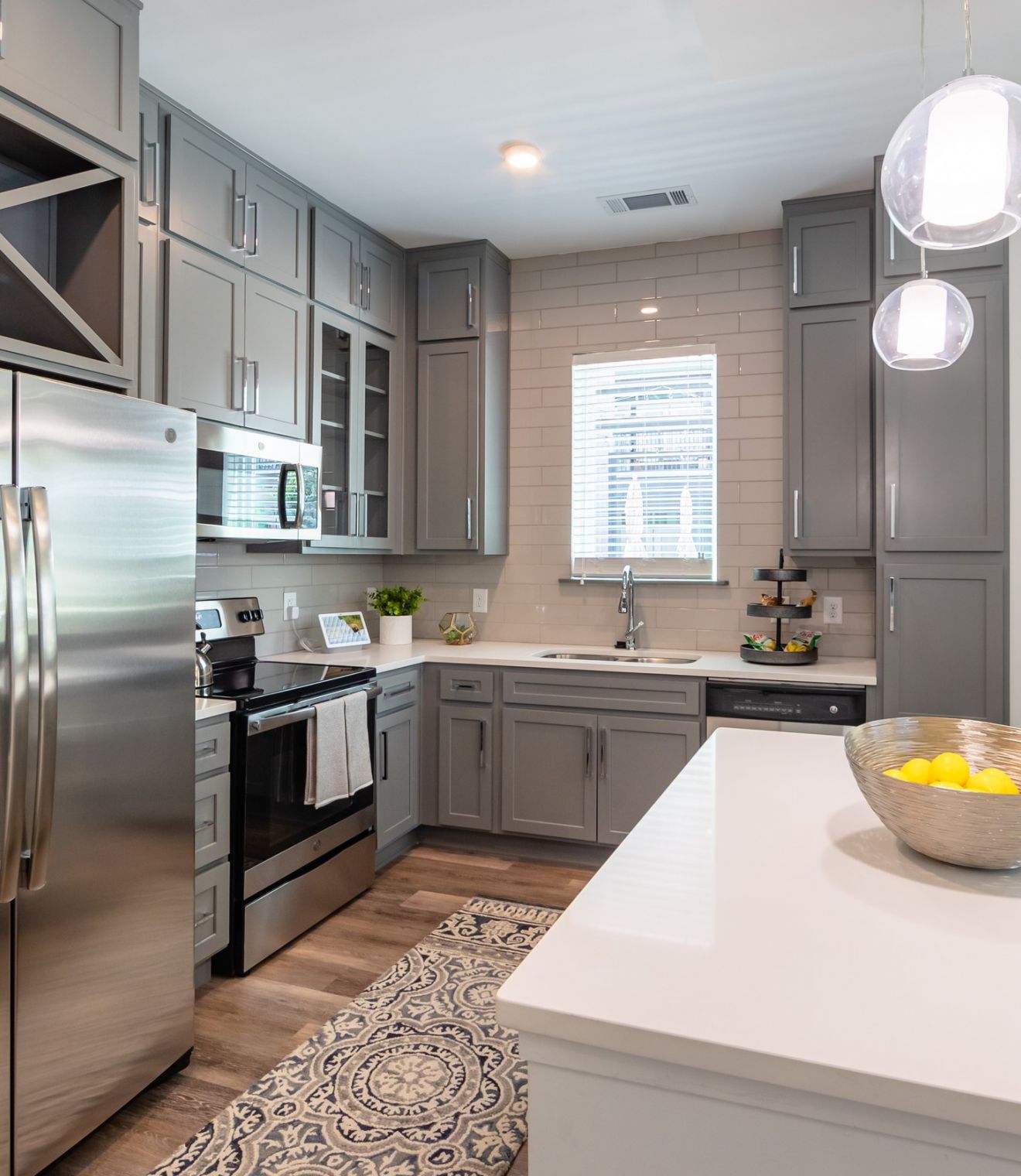 Uptown 550 Midrise spacious kitchen with custom cabinetry and stainless steel appliances