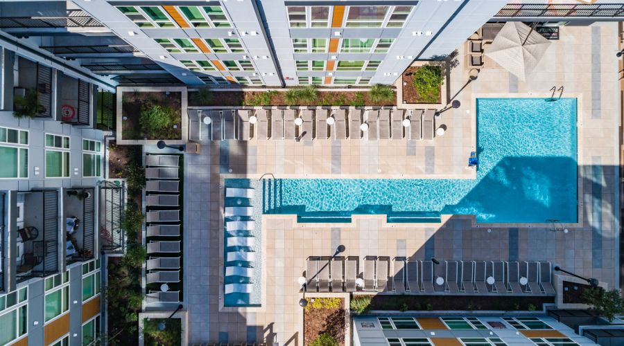 Uptown 550 Luxury apartment building pool with seating area around it.